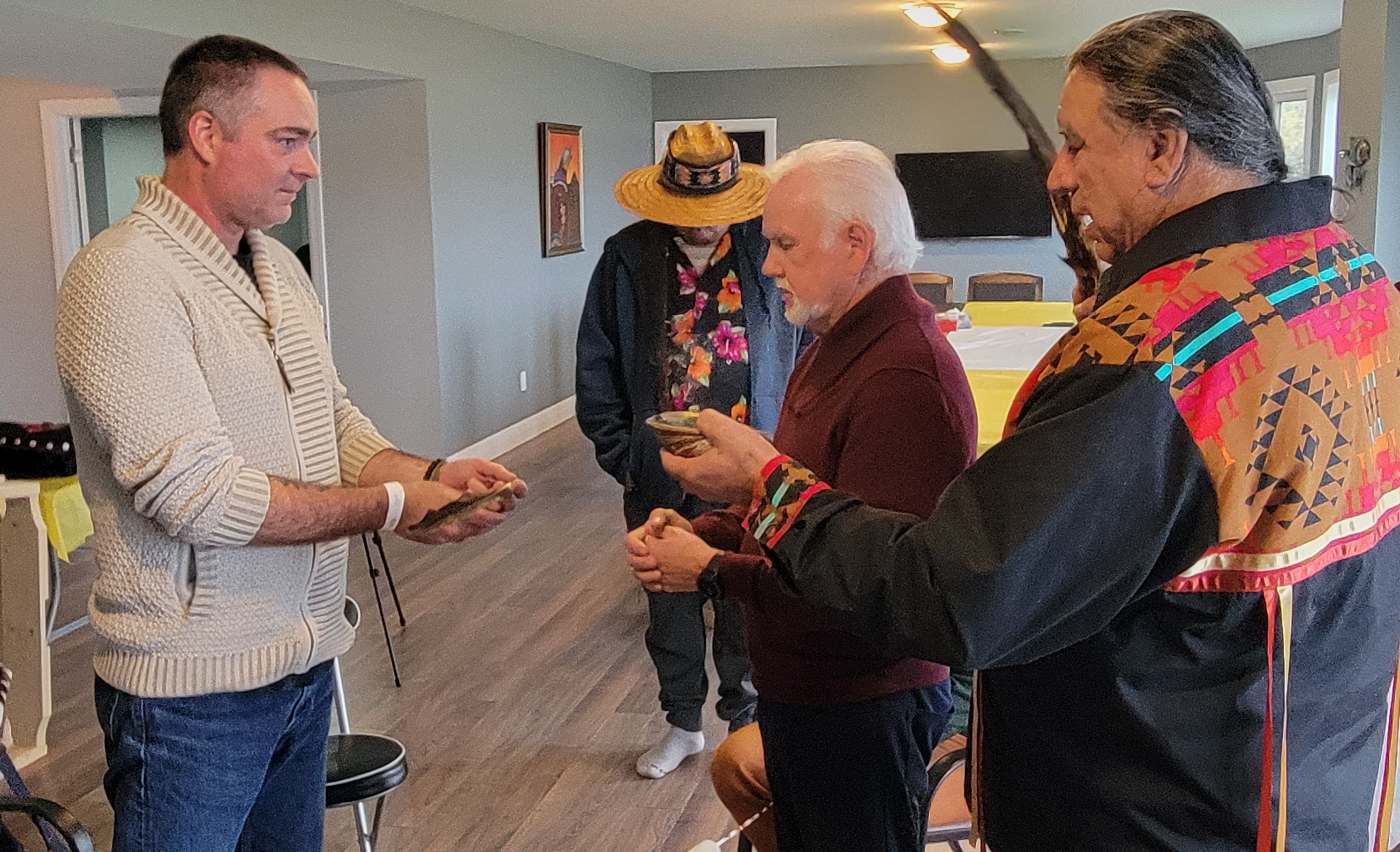 Chief Roger Augustine gifts Brad Loiselle an Eagle Feather with peace and friendship