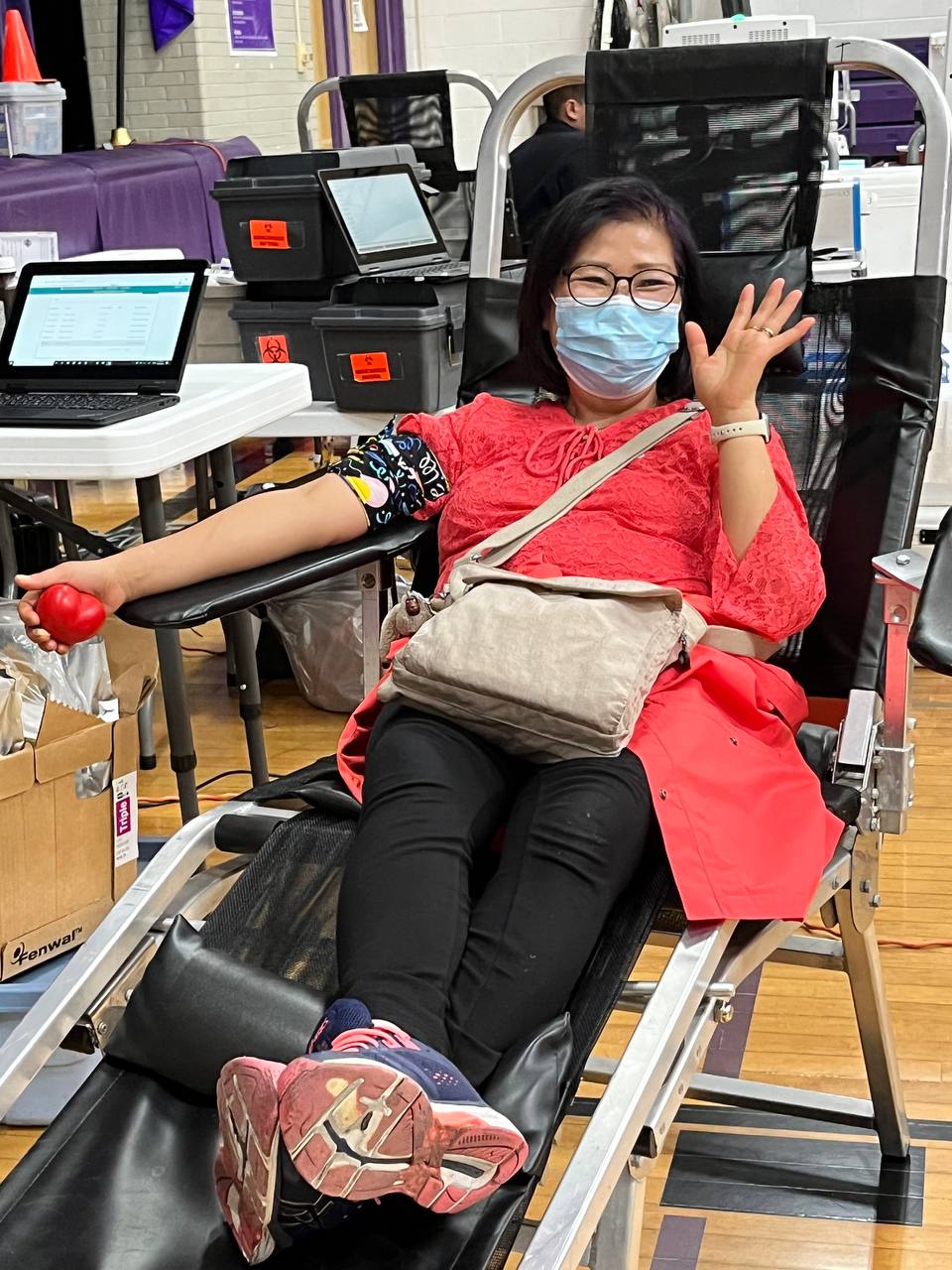 Happy donor from community donates blood