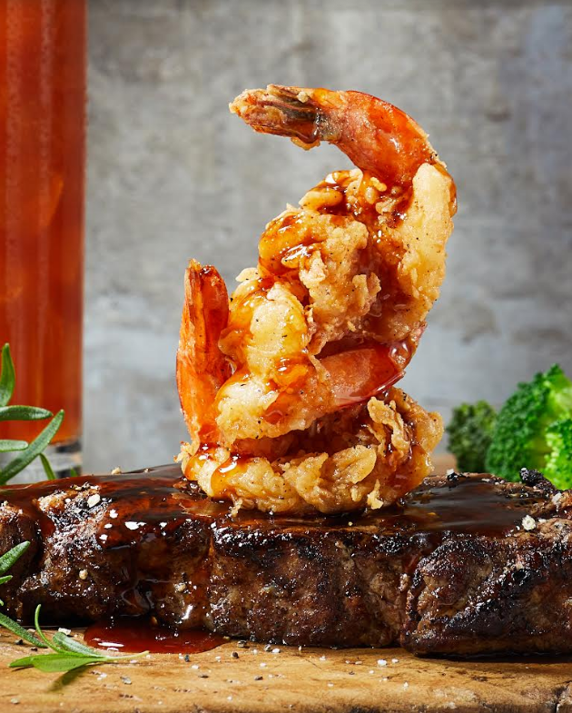 Firebirds Wood Fired Grill is offering summertime guests its Chef&#39;s Features, new lunch and dinner entres that celebrate July through July 31. To celebrate August, a new selection of entres are available August 1 - 31. Photo: Firebirds&#39; Wood Grilled NY Strip with Crispy Shrimp and Sticky Hot Honey Sauce, available now through July 31. Visit https://firebirdsrestaurants.com