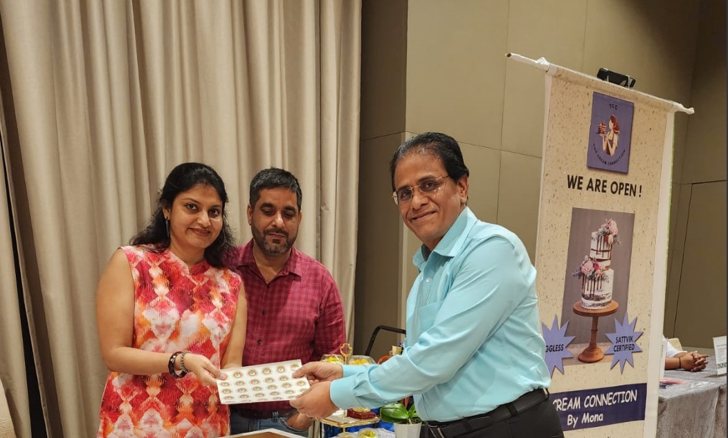 Mrs Mona of Cream Connections receiving the Sattvik certified Stickers from Venkat Kumar SCSG