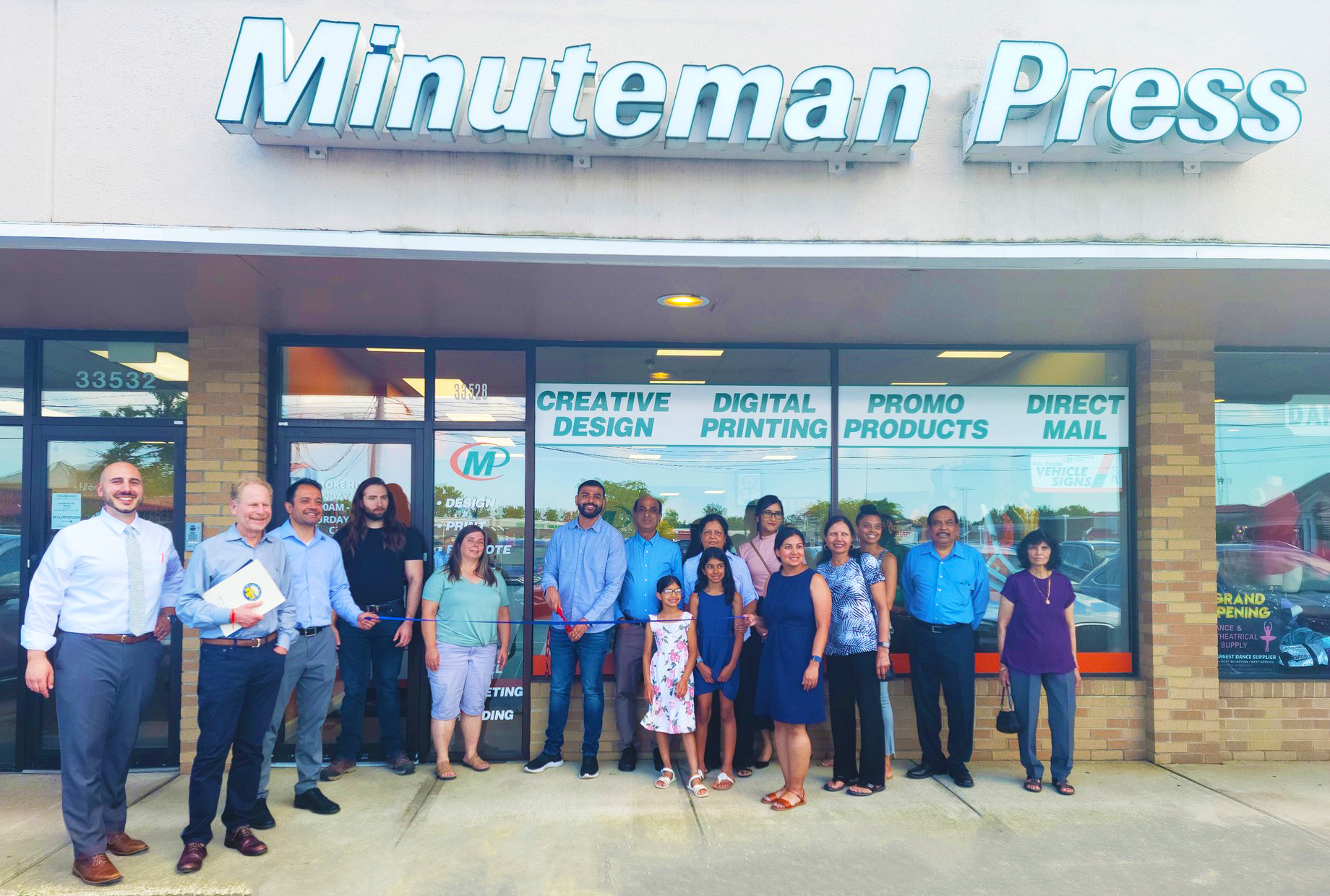 Minuteman Press franchise owner Nil Patel (center, with scissors) and attendees celebrated the grand opening of Minuteman Press in Solon, Ohio in September of 2023.