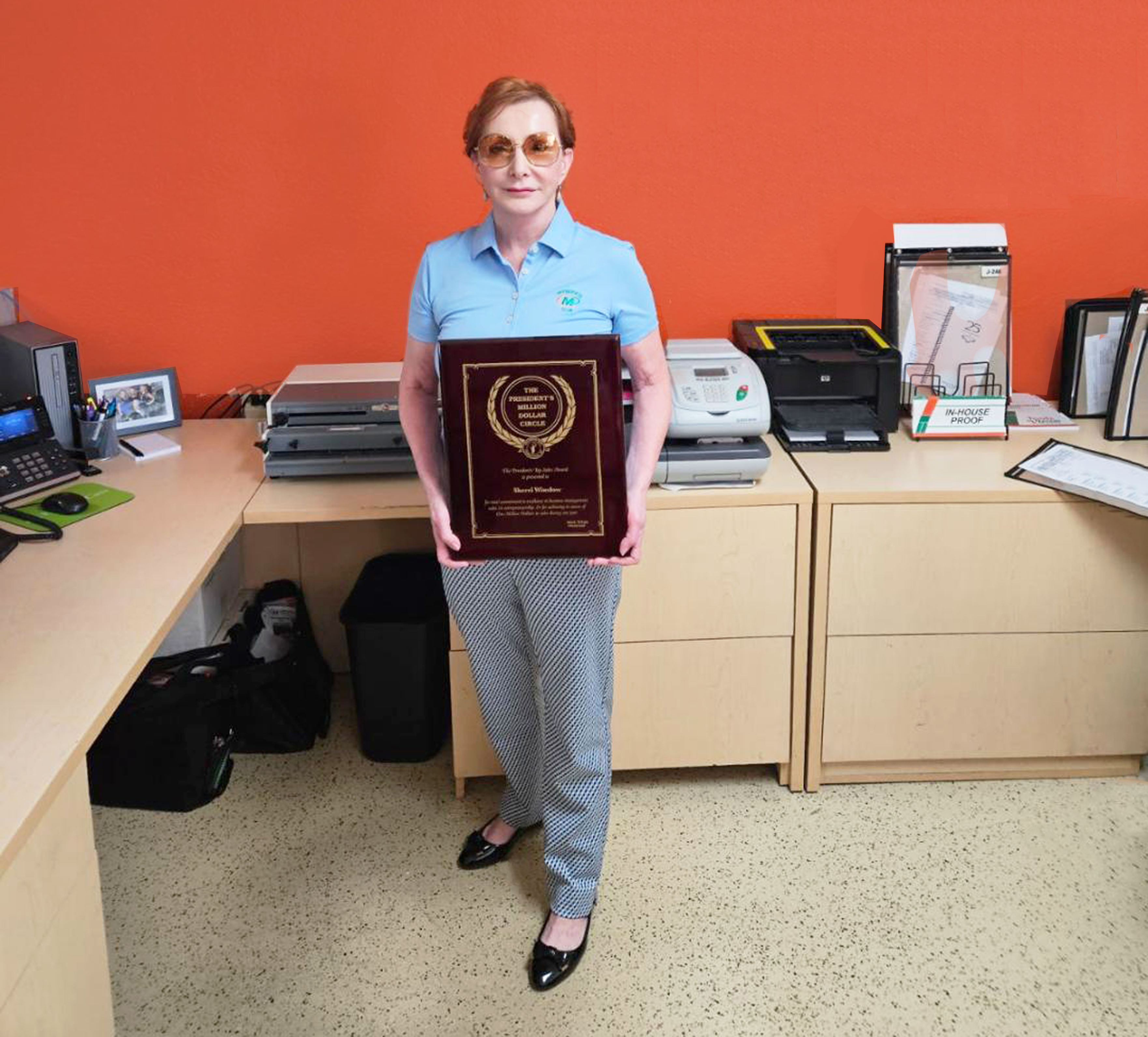 Minuteman Press franchise owner Sherri Winslow with her well-earned Presidents Club plaque at her center in Palm Desert, CA.
