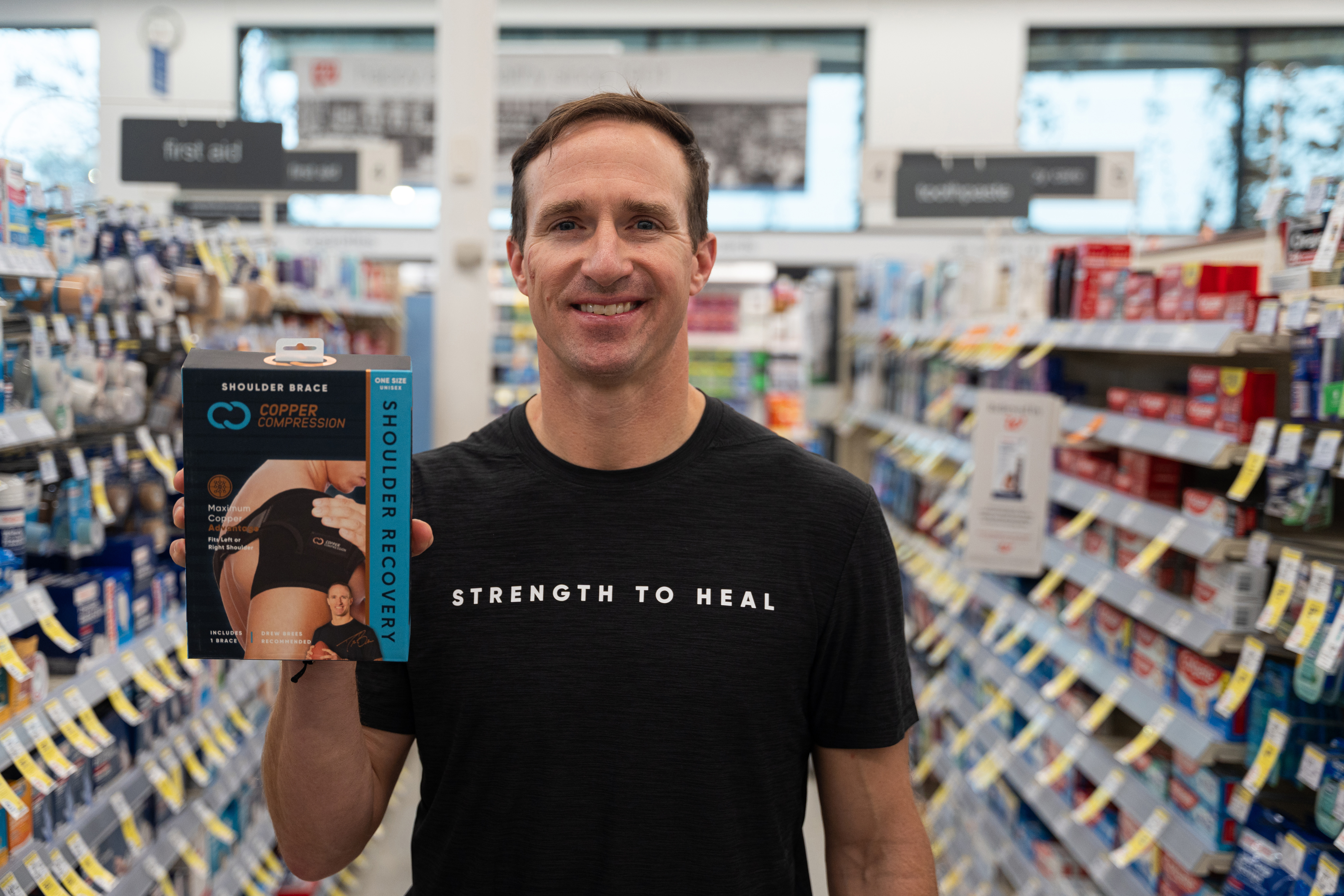 Drew Brees with the Copper Compression Recovery Shoulder Brace in the Support &amp; Braces aisle at his local Walgreens